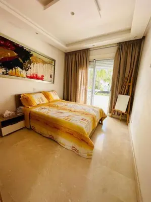 a bedroom with a bed and a large window at villa pour location vacances in Tamaris