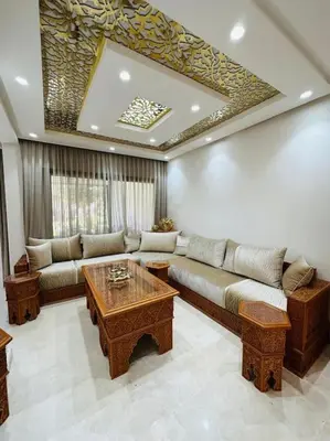 a living room with a couch and a table at villa pour location vacances in Tamaris