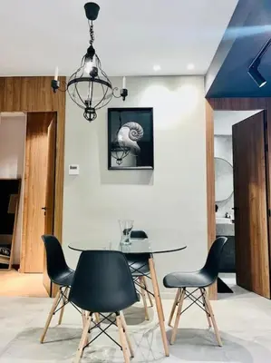 a dining room with a table and chairs and a chandelier at Studio Raffiné en Plein Gauthier in Casablanca