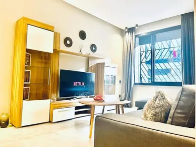 a living room with a couch and a table at Studio Raffiné en Plein Gauthier in Casablanca