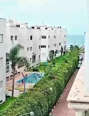 a row of white apartment buildings with a swimming pool at Appartement, Salam Beach in Pont Blondin