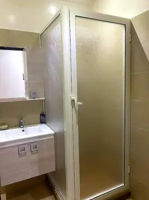 a bathroom with a shower and a sink at Appartement, Salam Beach in Pont Blondin