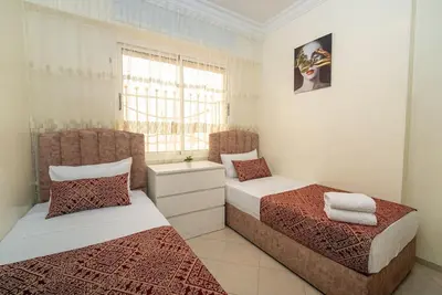 a bedroom with two beds and a window at Casablanca mosquée hassan 2 in Casablanca