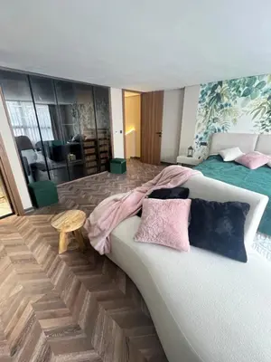 a bedroom with two beds and a couch with pillows at Quart des hôpitaux duplex luxe et sérénité in Casablanca