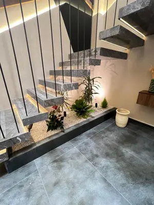 a lobby with a staircase with potted plants at Quart des hôpitaux duplex luxe et sérénité in Casablanca