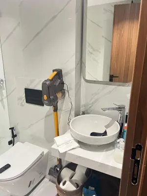 a bathroom with a sink and a toilet and a mirror at Quart des hôpitaux duplex luxe et sérénité in Casablanca