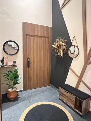 a room with a wooden door and a rug at Quart des hôpitaux duplex luxe et sérénité in Casablanca