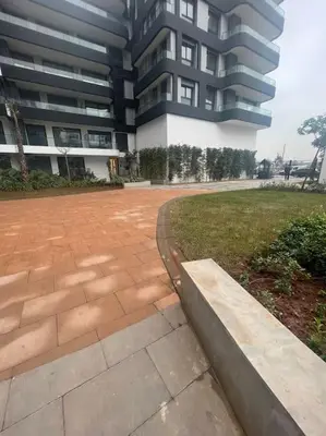 a large building with a brick walkway in front of a building at Perfect stay at CFC near Aeria Mall in Casablanca