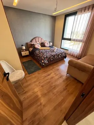 a bedroom with a bed and a chair and a window at Perfect stay at CFC near Aeria Mall in Casablanca