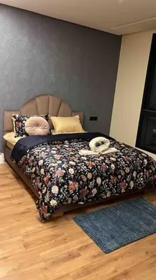 a bedroom with a bed with a dog laying on it at Perfect stay at CFC near Aeria Mall in Casablanca