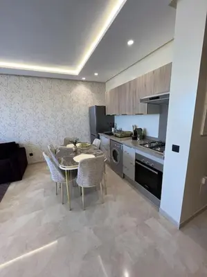 a kitchen with a table and chairs in a room at Perfect stay at CFC near Aeria Mall in Casablanca