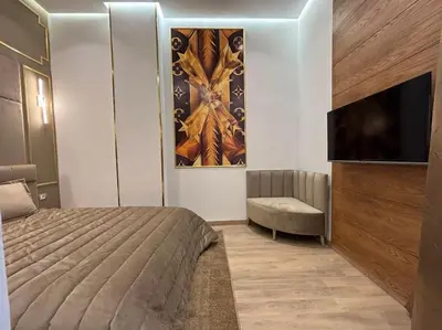 a bedroom with a bed and a flat screen tv at Corniche Casablanca- Suite Luxueuse Gold Star in Casablanca