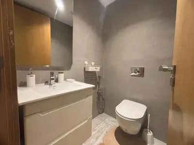 a bathroom with a white toilet and a sink at Corniche Casablanca- Suite Luxueuse Gold Star in Casablanca