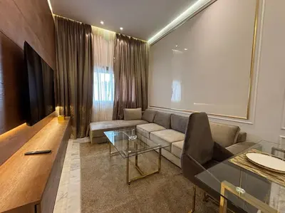 a living room with a couch and a glass table at Corniche Casablanca- Suite Luxueuse Gold Star in Casablanca