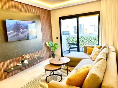 a living room with a couch and a table at Confort & Charme à Casablanca in Maarif