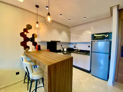 a kitchen with a wooden counter and a blue refrigerator at Confort & Charme à Casablanca in Maarif