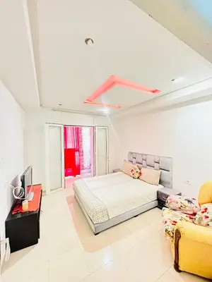 a bedroom with a bed and a couch at ONOMSUIT-Appartement en plein centre ville RABAT in Rabat