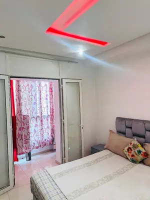 a bedroom with a bed and a red ceiling at ONOMSUIT-Appartement en plein centre ville RABAT in Rabat
