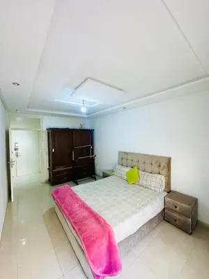a bedroom with a bed with a pink blanket on it at ONOMSUIT-Appartement en plein centre ville RABAT in Rabat