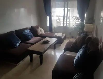 a living room with two couches and a coffee table at Appartement haut standing in Casablanca