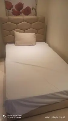a white bed with a pillow on top of it at Appartement haut standing in Casablanca