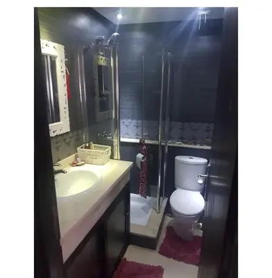a bathroom with a toilet and a sink and a shower at Appartement haut standing in Casablanca