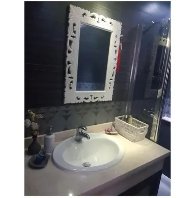 a bathroom with a sink and a mirror on a counter at Appartement haut standing in Casablanca