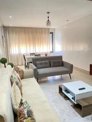 a living room with a couch and a table at 2 bedroom cozy apartment ,near CFC,in center casablanca in Casablanca