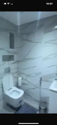 a bathroom with a white toilet in a room at أجمل شقة الوفاق in Temara