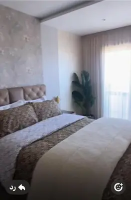 a bedroom with two beds and a window at أجمل شقة الوفاق in Temara