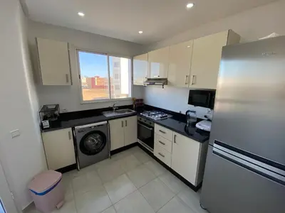 a kitchen with a refrigerator and a dishwasher at Cozy apartment in Mohammedia in Mohammedia
