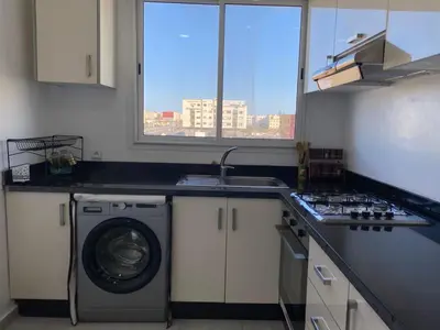 a kitchen with a washing machine and a sink at Cozy apartment in Mohammedia in Mohammedia