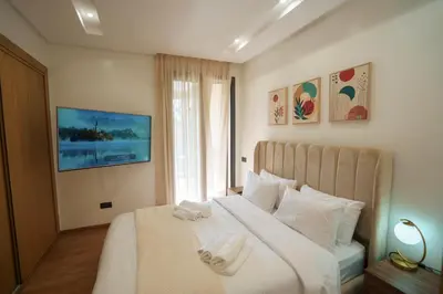 a bedroom with a white bed with towels on it at Emplacement Central Lumineux & Chic Prés de Station Tramway KFC Et Carrefour Abdelmoumen Et 2 Mars Casablanca in Casablanca
