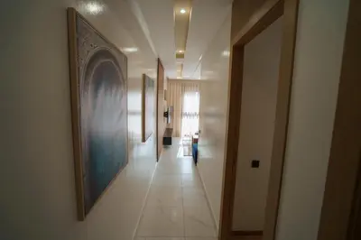 a hallway with paintings on the walls and a hallway with at Emplacement Central Lumineux & Chic Prés de Station Tramway KFC Et Carrefour Abdelmoumen Et 2 Mars Casablanca in Casablanca