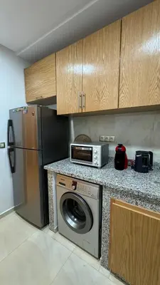 a kitchen with a washing machine and a refrigerator at Ksar Labhar City Escape in Rabat