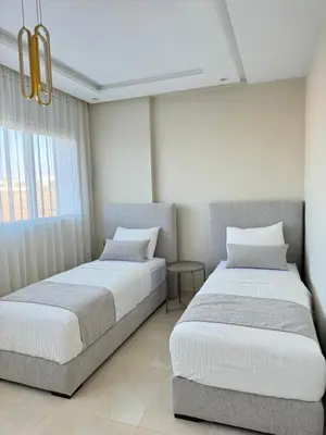 a bedroom with two beds and a window at Ksar Labhar City Escape in Rabat