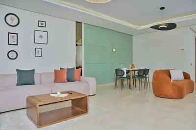 a living room with a couch and a table at YourPlace - Modern, Spacious 3BR in Prestigia in Rabat