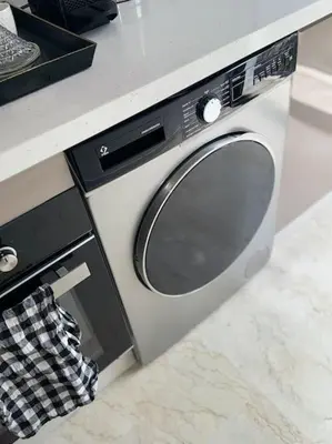 a washing machine sitting under a counter in a kitchen at 35 Appartement ensoleillé calme et NEUF in Casablanca