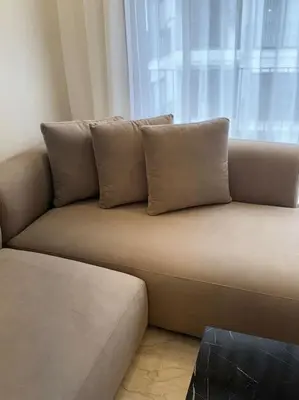 a couch with pillows on it in a room at 35 Appartement ensoleillé calme et NEUF in Casablanca