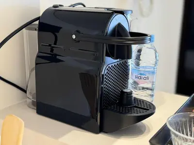 a toaster sitting on a counter with a bottle of water at 36 Studio luxueux corniche 5 min in Casablanca