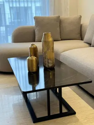 a living room with a couch and a table with two vases on it at 36 Studio luxueux corniche 5 min in Casablanca