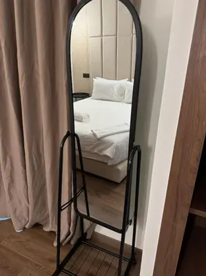 a mirror next to a bed in a room at 36 Studio luxueux corniche 5 min in Casablanca