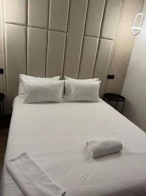 a white bed with a pillow on top of it at 36 Studio luxueux corniche 5 min in Casablanca