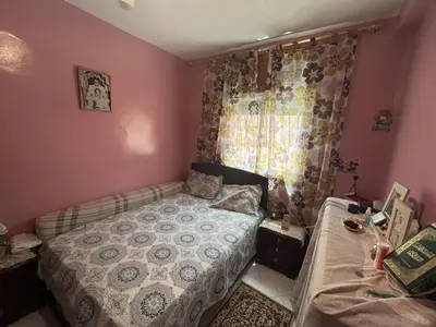a small bedroom with a bed and a window at Oulfa in Casablanca