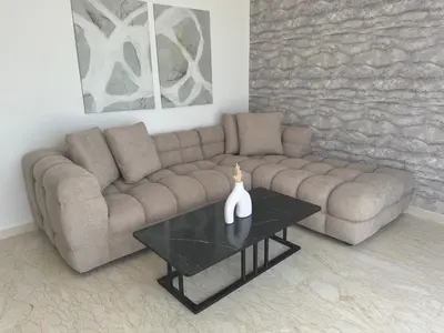 a living room with a couch and a table at 38 Studio luxueux- Corniche à 5 min in Casablanca