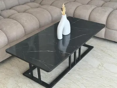a black coffee table with a white vase on it at 38 Studio luxueux- Corniche à 5 min in Casablanca