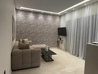 a living room with a couch and a tv at 38 Studio luxueux- Corniche à 5 min in Casablanca