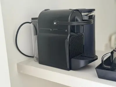 a black appliance is sitting on a shelf at 38 Studio luxueux- Corniche à 5 min in Casablanca