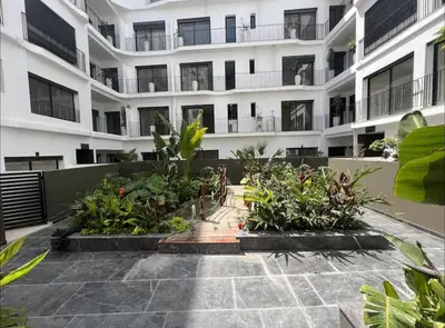 an apartment building with a courtyard with plants at 47 Appartement luxueux proche de la mer in Casablanca