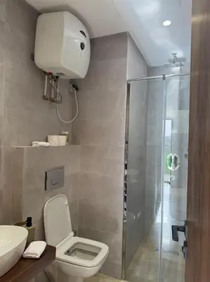 a bathroom with a shower and a toilet and a sink at 47 Appartement luxueux proche de la mer in Casablanca